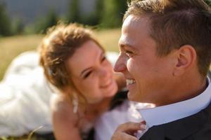 Wedding photography in the mountains. The bride and groom hug tightly. photo