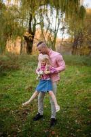 Father, daughter and mother walking outdoors. Happy family. photo