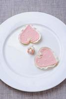 many pink cookies on a white plate photo