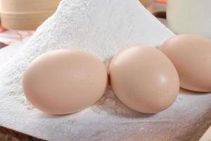 Chicken eggs with slices of bread on the table with milk photo