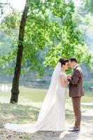 The groom holds the hands of his beloved. photo