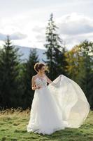 Wedding photography in the mountains. The bride and groom hug tightly. photo