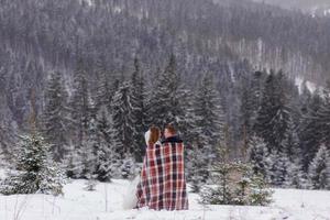 The groom leads his bride by the hand to a lonely old beech. Winter wedding. Place for a logo. photo