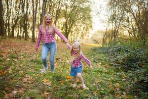 Father, daughter and mother walking outdoors. Happy family. photo