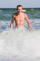 a man walking along the seashore photo