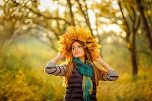 Portrait of a young girl in the autumn park. photo