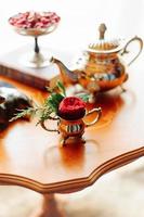 Roses on a table in candlesticks photo