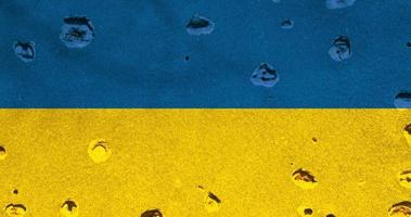 Ukrainian flag with bullet holes on the facade of a residential building as a background. Flag of Ukraine. Stop the war. Armed conflicts. Defund the armies. No to war. video