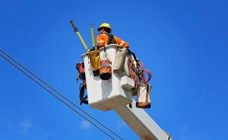 Electrician fixing electric lines photo