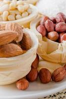 waffle basket with coffee beans, coconut, raisins, almonds, peanuts, hazelnuts and pine nuts photo