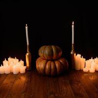 Halloween pumpkin on the background of candles and a black background. photo