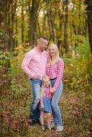 Father, daughter and mother walking outdoors. Happy family. photo