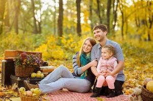 family walking in autumn park photo