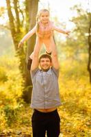 family walking in autumn park photo