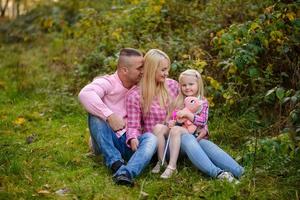 Father, daughter and mother walking outdoors. Happy family. photo