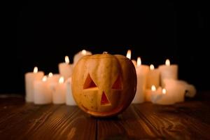 Halloween pumpkin on the background of candles and a black background. photo