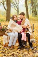 family walking in autumn park photo