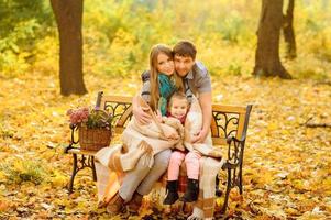 family walking in autumn park photo