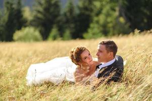 Wedding photography in the mountains. The bride and groom hug tightly. photo