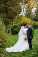 The bride and groom on the background of the autumn park. photo