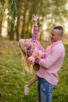 Father, daughter and mother walking outdoors. Happy family. photo