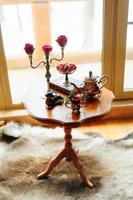 Roses on a table in candlesticks photo