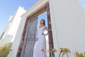 Portrait of a beautiful bride in a white dress at the gate photo