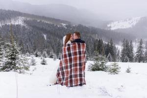 The groom leads his bride by the hand to a lonely old beech. Winter wedding. Place for a logo. photo