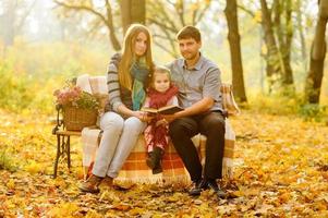 family walking in autumn park photo