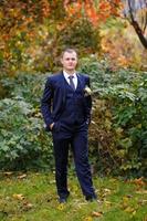 The bride and groom on the background of the autumn park. photo