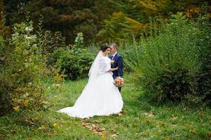 The bride and groom on the background of the autumn park. photo