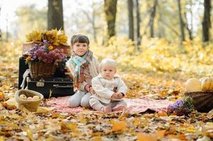 dos hermanitas se abrazan en la playa durante un picnic en el parque. otoño. foto