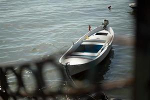 Single boat with sea and beach view with other boats on background photo