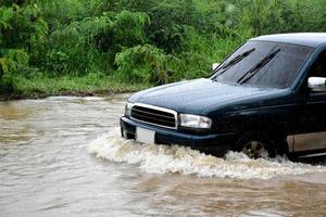 Pickup car and vehicle in floodwater, car insurance and dangerous situation concept. photo