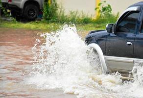 Pickup car and vehicle in floodwater, car insurance and dangerous situation concept. photo