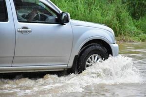 Pickup car and vehicle in floodwater, car insurance and dangerous situation concept. photo