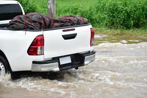 Pickup car and vehicle in floodwater, car insurance and dangerous situation concept. photo