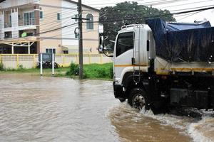 Pickup car and vehicle in floodwater, car insurance and dangerous situation concept. photo