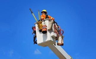 Electrician fixing electric lines photo