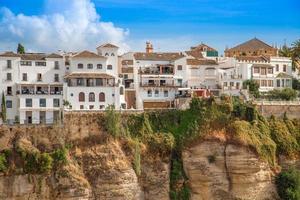 Famous Ronda restaurants and colonial houses overlooking the scenic gorge and the Puente Nuevo bridge photo