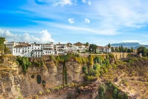 Famous Ronda restaurants and colonial houses overlooking the scenic gorge and the Puente Nuevo bridge photo