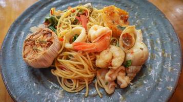 Stir-fried spicy seafood pasta Thai style Spaghetti Pad Kee Mao Talay. photo