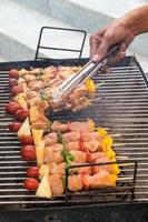 Man cooking meat on barbecue photo