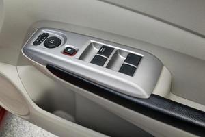 car interior details of door handle with windows controls and adjustments photo