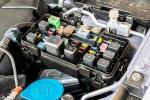 Auto mechanic checking a car fuse photo