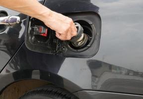 Hand opening the oil filler cap photo