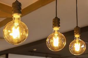 Group of old copper lamps hanging from the ceiling photo