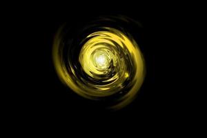 Glowing golden light vortex on black backdrop, abstract background photo