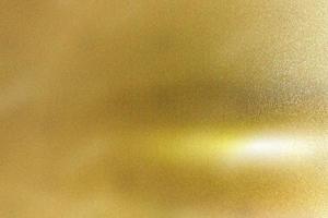 Light shining down on gold foil metal plate with copy space, abstract texture background photo