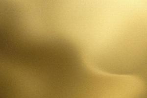 Shiny brushed golden wave metal, abstract texture background photo